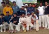 Winning team posing for a group photograph along with tournament cup at KC Sports Ground Jammu.