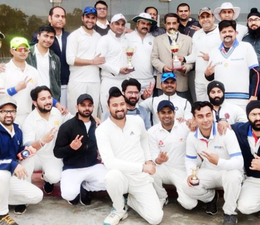 Winning team and dignitaries posing for a group photograph along with trophy at GGM Science College Ground Jammu.