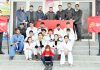 Judo players posing for a group photograph along with dignitaries outside Indoor Sports Hall of Polo Ground Srinagar.