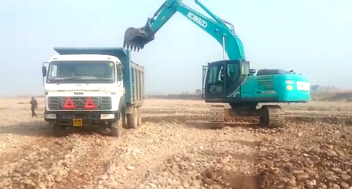An excavator digging near Ujh bridge and loading Tipper at Kotpunnu in Kathua. -Excelsior/Pardeep
