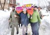 Cops and locals shift pregnant woman to hospital at Keller in Shopian district on Wednesday. —Excelsior/Younis Khaliq