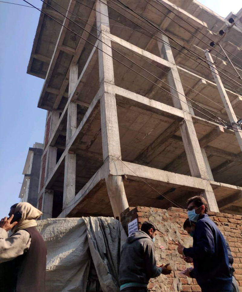 JMC team in the process of sealing an illegally raised building.