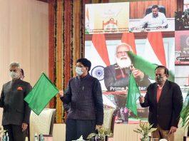 Union Railway Minister Piyush Goyal, External Affairs Minister S Jaishankar and Health Minister Harsh Vardhan wave green flags as Prime Minister Narendra Modi virtually flags off eight trains connecting Statue of Unity in Kevadia, Gujarat with different regions of the country, at Nizamuddin Railway Station in New Delhi on Sunday.