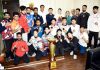 Wushu Junior team posing for a group photograph along with Secretary J&K Sports Council, Nuzhat Gul and winning trophy at Jammu.