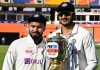 Rishabh Pant, left, looks on as teammate Axar Patel holds the winners trophy after winning fourth cricket test match against England at Narendra Modi Stadium in Ahmedabad on Saturday. (UNI)