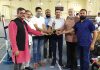 Former Minister Sham Lal Sharma and other dignitaries presenting trophy to a player during closing ceremony of Gold Badminton Championship at Akhnoor.