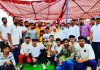 Former Minister Sham Lal Sharma posing for a group photograph with winning team along with trophy at Akhnoor.