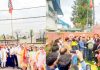 BJP leaders hoisting party flag at Jammu (L) and Srinagar (R) on Tuesday.