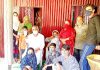 Former MLA Ramban, Ashok Kumar posing for a photograph with members of affected families of Chamba hamlet.