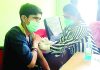 A young budding cricket player getting COVID dose during vaccination camp at Jammu.