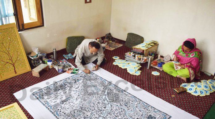 An award-winning ‘Paper Mache’ artist in Srinagar, Maqbool Jan making a map of Srinagar city on a cloth by using ‘Paper Mache’ techniques. —Excelsior/Shakeel