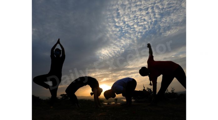 Yoga at Sunrise. — Excelsior/Rakesh