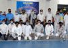 Fencers posing for group photograph with dignitaries at Indoor Hall MA Stadium.