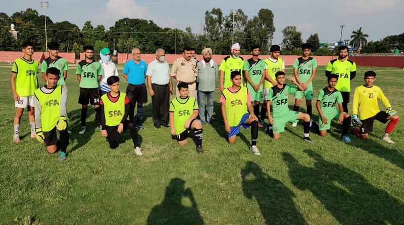 Players posing for a group photograph with dignitaries at Sports Stadium Kathua.