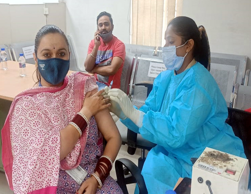 A woman getting vaccine dose during a camp at Passport Seva Kendra Jammu on Saturday.