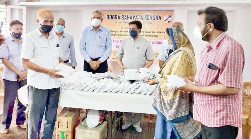 DSK chairman, Gulchain Singh Charak handing over COVID kits to members of DSK unit at Jammu on Monday.