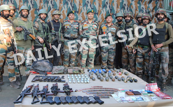 Troops with arms and ammunition recovered from three militants killed in Uri sector. —Excelsior/Abid Nabi
