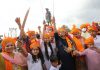 Rajput women and children celebrating birthday of Maharaja Hari Singh in front of his statue installed near main Tawi Bridge, Jammu. Excelsior/Rakesh