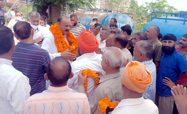 Senior NC leader Surjeet Singh Slathia interacting with people at a border village in Ramgarh area of Samba district.