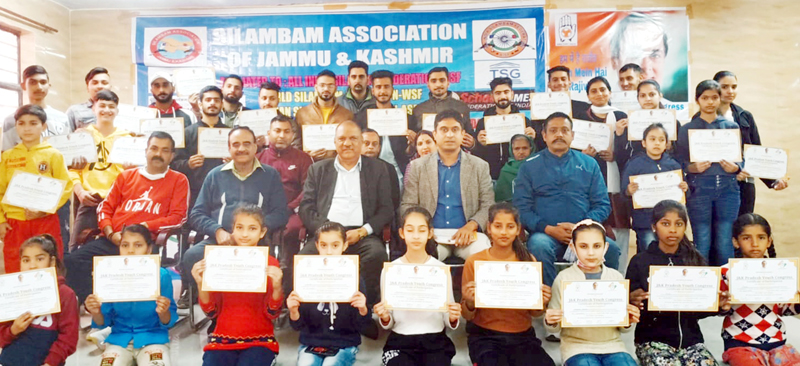Winners displaying their meritorious certificates while posing with former Minister Mula Ram and others at Raipur Domana.