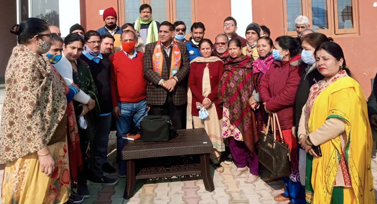 JMC Mayor, Chander Mohan Gupta posing for a group photograph with residents of Jagti Camp in Jammu on Tuesday.