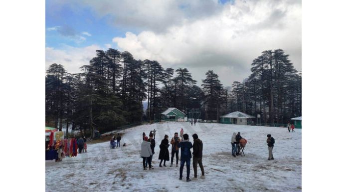 Tourists enjoy snowfall at Patnitop on Monday. -Excelsior/Parvaiz Mir