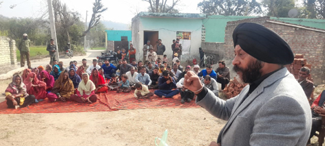 Manjit Singh addressing a public meeting at village Vardhan in Samba on Sunday.