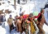A pregnant woman being carried by policemen from snowclad Chilly village up to hospital in Doda. -Excelsior/Rafi Choudhary