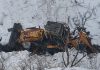 A JCB which fell into deep gorge from snow-clad road in Gandoh area of Doda. —Excelsior/Rafi Choudhary