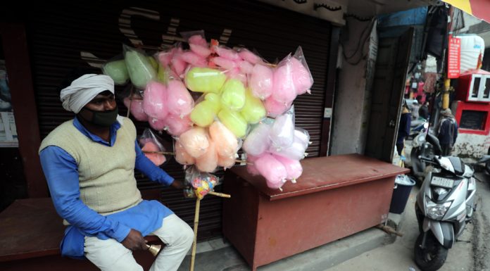 A man waits for customers as he sells cotton candies at Old City in Jammu. — Excelsior/Rakesh