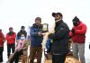 Executive Councillor Tourism, Phunsok Tashi awarding a player during the event at Kargil. -Excelsior/Basharat Ladakhi