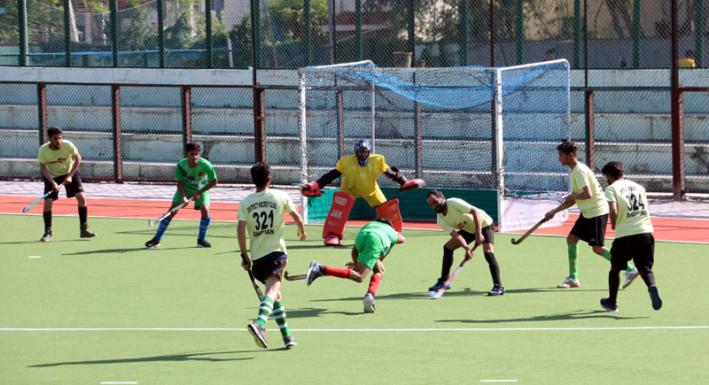 Players in action during a Hockey match at KK Hakku Stadium in Jammu.