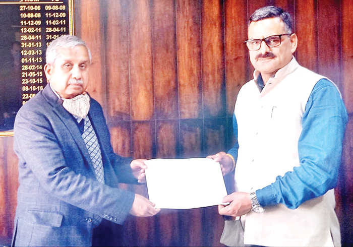BJP leader, Sanjay Baru handing over land acquisition papers to Rajan Mengi, CE, PMGSY at Jammu on Saturday.