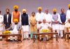 Punjab Governor Banwarilal Purohit, Haryana Governor Bandaru Dattatreya and Punjab Chief Minister Bhagwant Mann in a group photo with newly sworn ministers of Punjab Government at Raj Bhawan in Chandigarh on Saturday. (UNI)
