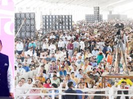 Prime Minister Narendra Modi waves to huge crowd at Palli Gram Panchayat in Samba district on Sunday. Also seen are Union Rural Development and Panchayati Raj Minister Giriraj Singh, Union MoS in PMO Dr Jitendra Singh and Lieutenant Governor Manoj Sinha. — Excelsior/Rakesh