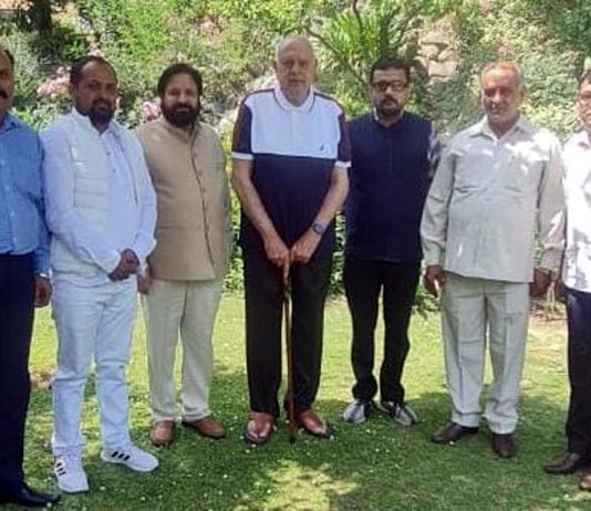 A delegation of NC posing for a group photograph with former CM, Dr. Farooq Abdullah at Srinagar.