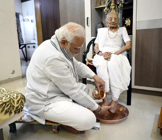 Prime Minister Narendra Modi seeks blessings of his mother as she enters 100th year, in Ahmedabad on Saturday. (UNI)