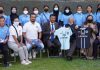 Lt.Governor R K Mathur and women football team players posing for group photograph.