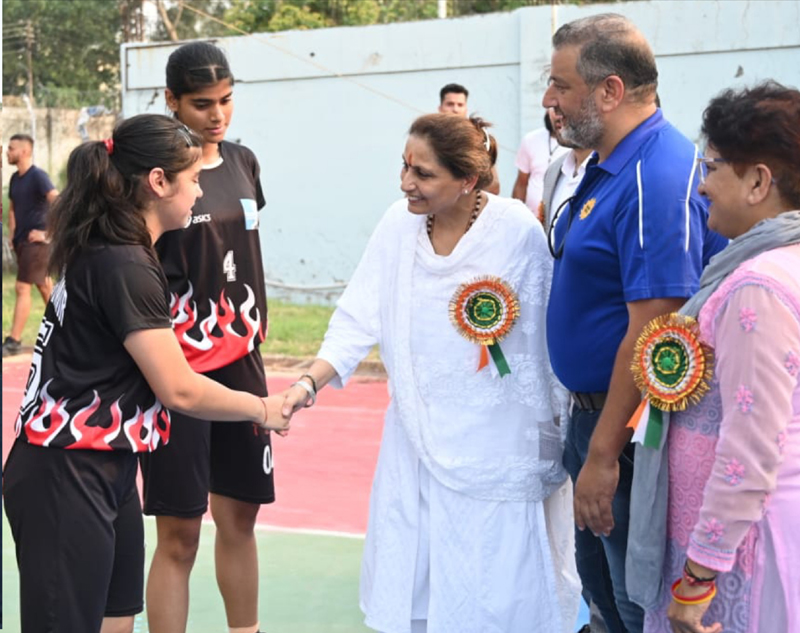 Chief Guest, Neelu Rohmetra- Director with Directorate of Distance Education interacting with players during commencement of the Basketball tournament at Jammu University on Monday.