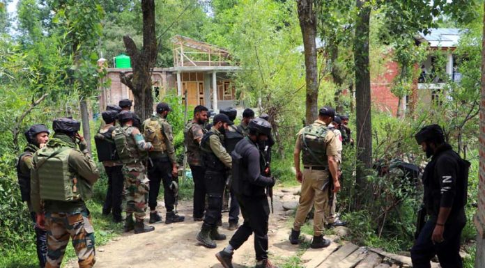 Security personnel at the school where militants shot dead a teacher at Gopalpora in Kulgam on Tuesday. (UNI)