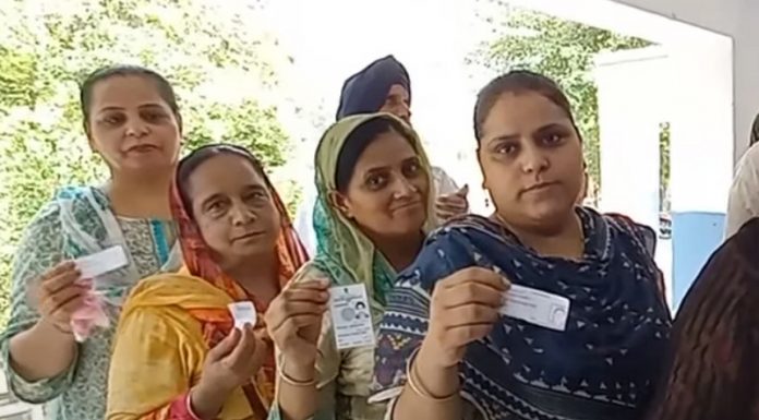 Sikh women displaying voter card while waiting for their turn to cast vote in DGPC elections on Monday.