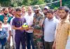 An Army officer handing over volleyball to a student in Surankote on Sunday.