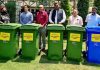 Senior officers of Income Tax Department posing with dustbins meant for donation in Srinagar city.