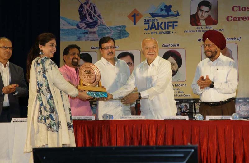 Former Union Home Minister Sushil Kumar Shinde presenting award to a filmmaker at closing ceremony of 1st Jammu Kashmir International Short Film Festival in Pune.