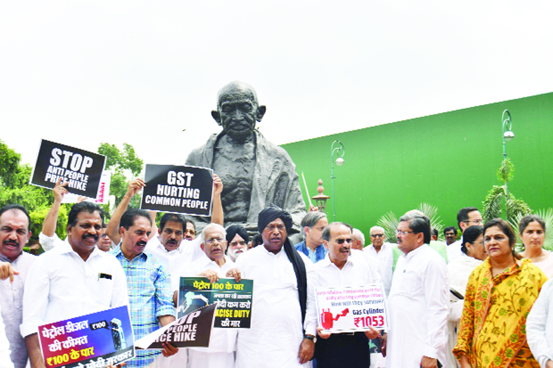 Opposition MPs protesting infront of the Mahatma Gandhi statue at Parliament during the Monsoon Session in New Delhi on Wednesday. (UNI)