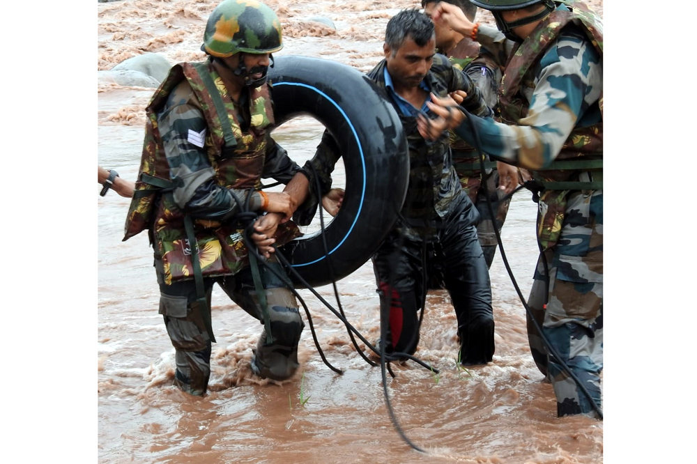 A youth being rescued from flooded river by Army jawans near Poonch on Sunday. -Excelsior/Romesh Bali