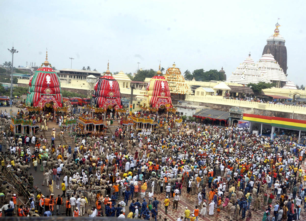 Devotees throng the chariots of Lord Jagannath, Lord Balabhadra and Goddess Subhadra during the annual Rath Yatra of Lord Jagannath, in Puri on Friday. (UNI)