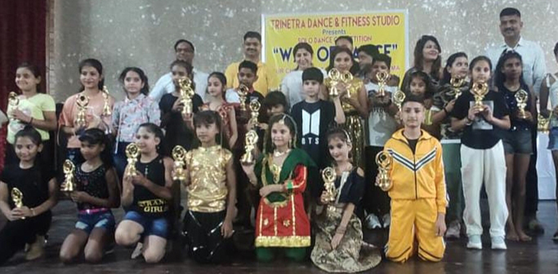 Winners of dance competition displaying trophies while posing with dignitaries at Polytechnic College, Jammu