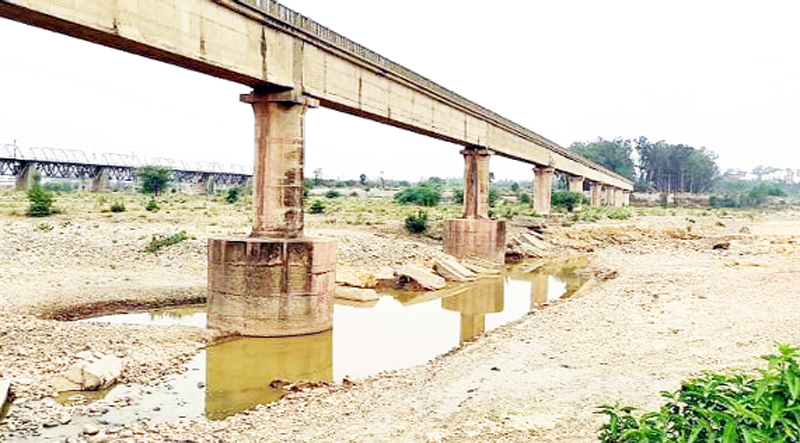 Illegal mining done under the Ravi Tawi canal aqueduct on river Basanter has exposed this super structure to a grave risk. -Excelsior / Nischant