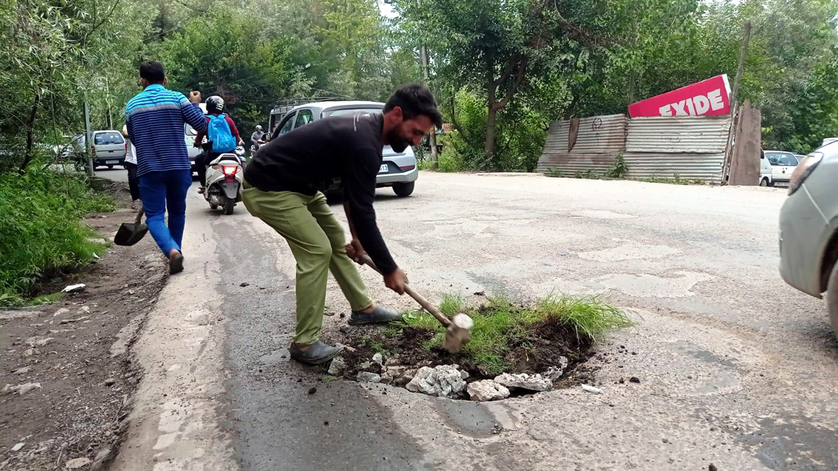 Residents filling road potholes.